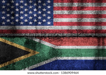 two flags on a cracked wall, USA and South Africa
