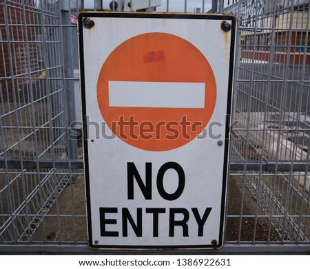 No Entry sign on wire fence in front of train tracks in Melbourne, Australia