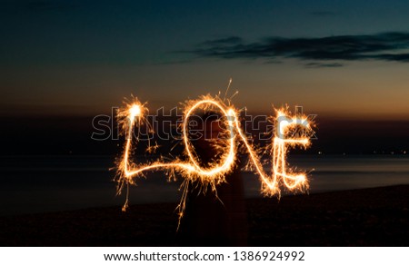  A firework sparkler used to scribe LOVE