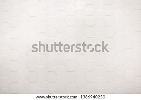 real photo of white hexagonal tiles wall in bathroom