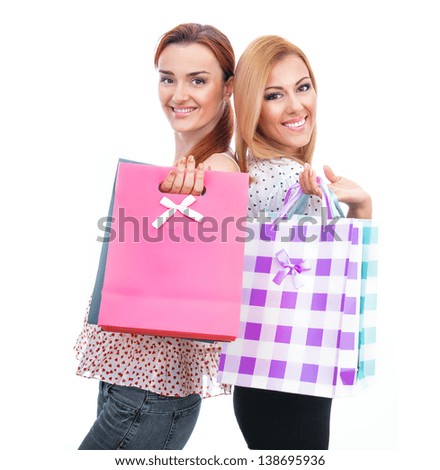 Happy friends two girls with shopping bags, isolated on white background