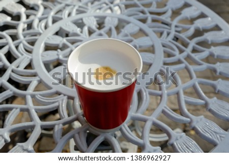 
beautiful red paper cup with latte in spring