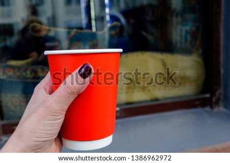 
beautiful red paper cup with latte in spring