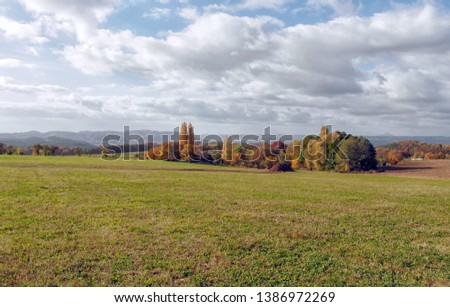 Autumn Landscape. Photo of fall landscape in beautiful Bohemian paradise in Czech republic. Field, trees and cloudy sky – beautiful nature.