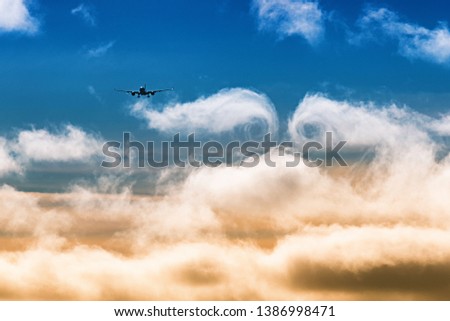 The plane flies through the clouds. The turbulence of the clouds left by the plane during the flight.  Airplane landing at Helsinki Airport, Finland.