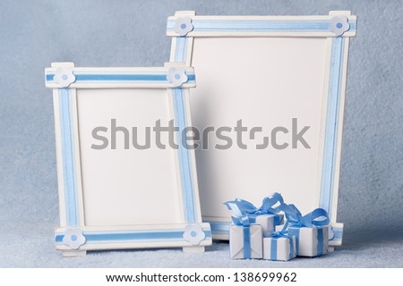 Photo frames with gifts on a blue background