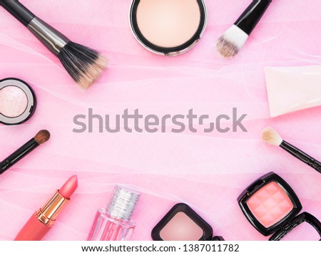 Lipstick, tools, eyeliner, blush, perfume, eye shadow and powder cosmetic in pink theme make up on frame for promotion. Set of decorative cosmetics. Copy space. 