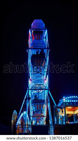 Ferris wheel at night with blue light.