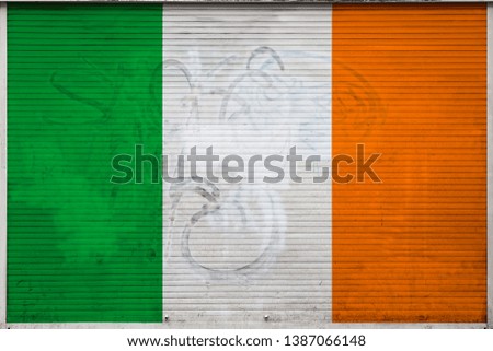 Close-up of old metal wall with national flag of Ireland Concept of Ireland export-import, storage of goods and national delivery of goods. Flag in grunge style