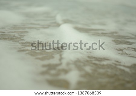 Close up photo of foam on ocean water at the beach in North Carolina.