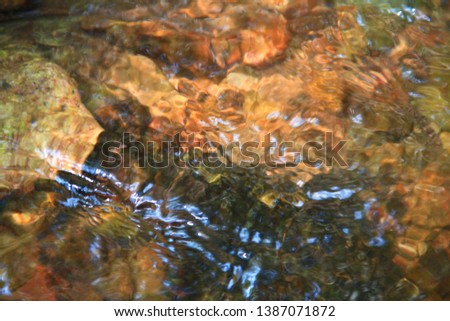 The clear water flows through the gravel are smooth and very cool. Originated from natural waterfall.