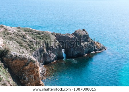 Scenic view of the waves of the blue sea among the rocks.