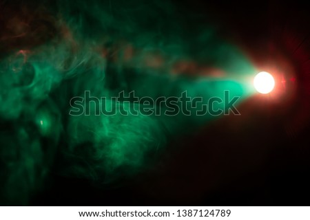 projector spotlight green color , smoke texture background . light beam screening and glowing for movie cinema and film multimedia production in dark black room at night . wide lens showing .