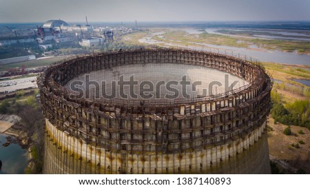 Aerial shot of a huge round construction in Chernobyl with water around