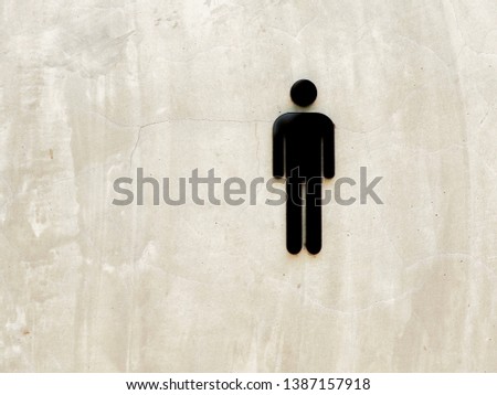 A sign on the plaster wall in front of the bathroom to indicate that it is a male of female bathroom.