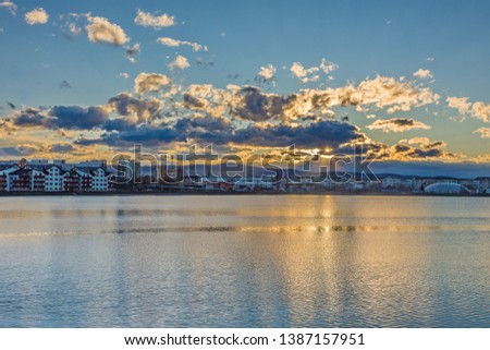 A photo with sunset over the lake 