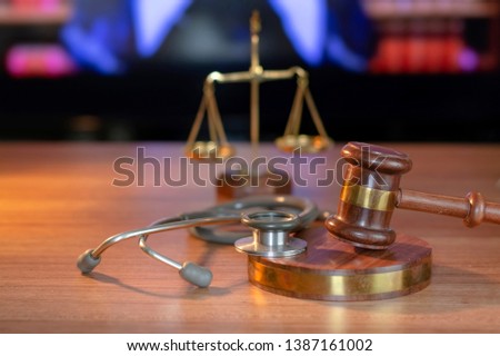Stethoscope with judge gavel. Concept of healthcare and medicine, malpractice, legal system.