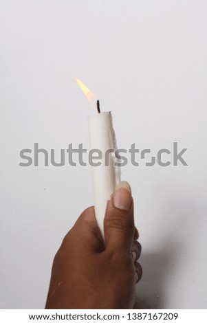 close up candle lit white in white background