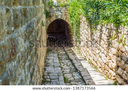 This is a capture of the old roads in Der El Kamar a village Located in Lebanon and you can see in the picture the old walk made of white stones with an historic architecture for walls and houses 