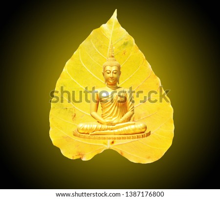 Buddha statue, meditation and a bright yellow Bodhi leaf as background Visakha Bucha Day Concept.