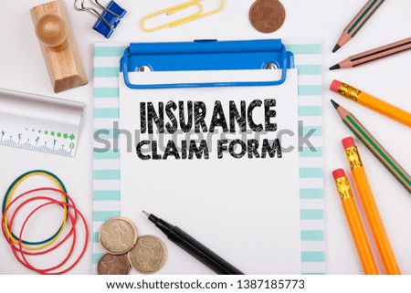 Insurance Claim Form. Office desk with stationery and mobile phone