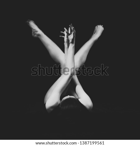 Female dancer posing on black background. Portrait of woman dancing indoors in studio. Beautiful body lines contemporary choreography.