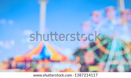 Vintage tone Abstract Blurred image of Theme park on day time with bokeh for background usage .