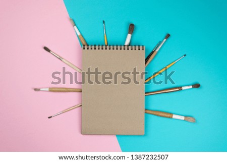 School notebook and various stationery. Back to school concept. Multicolored background.