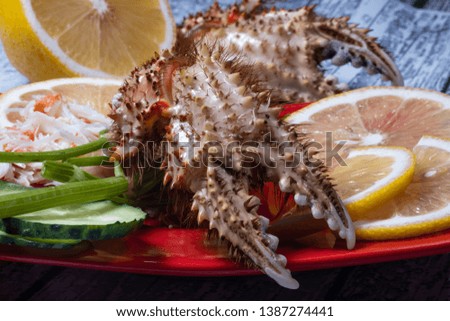 Seafood. Crab tentacles and claws on a red plate. With lemon and