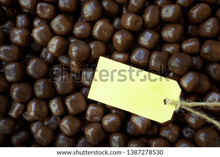 Creative layout made of chocolate candies with tag for copy space
