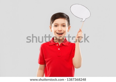 party props, photo booth and communication concept - smiling little boy in red polo t-shirt holding blank speech bubble over grey background Royalty-Free Stock Photo #1387368248