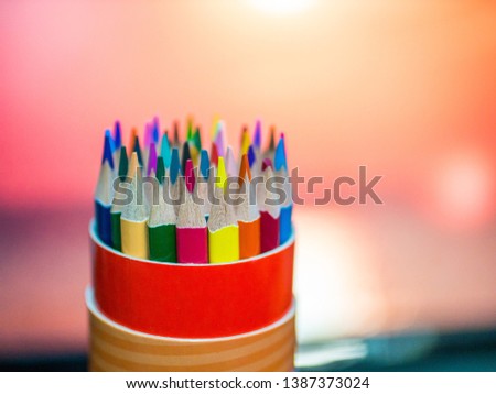 Set of colored pencils in a round pencil case macro close-up