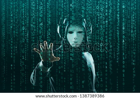 Computer hacker in mask and hoodie over abstract binary background. Obscured dark face. Data thief, internet fraud, darknet and cyber security.
