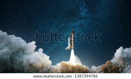 Spaceship takes off into the starry sky. Rocket starts into space. Concept Royalty-Free Stock Photo #1387394786