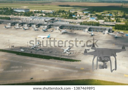 Unmanned aerial vehicle (drone) flying over the airport, flight disruption concept 