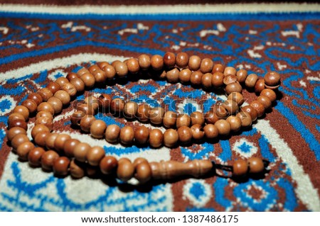 Prayer beads on prayer rug. Islamic background. Ramadan karem. Selective focus