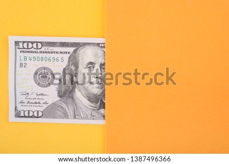 100 dollar  on a yellow background