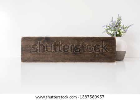 Blank brown long horizontal wood sign with vase and flowers, rustic mock up