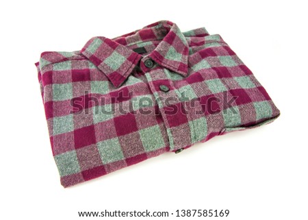 Red checkered shirt folded isolated on white background.