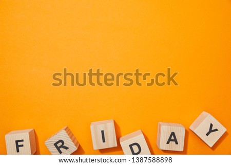 top view of wooden cubes with letters on orange surface