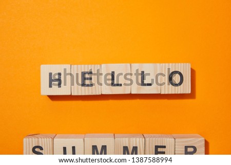top view of wooden cubes with letters on orange surface