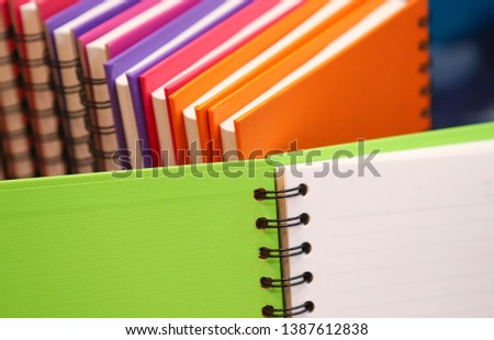 Closeup of a pile of colorful notebooks preparing for using in training course.