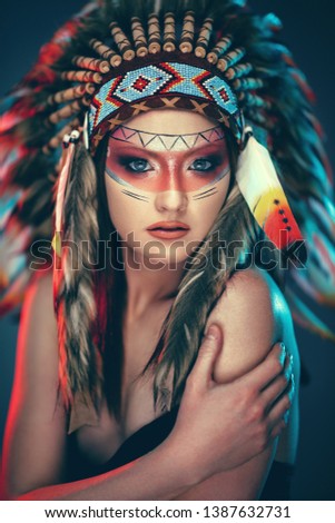 Native young Indian American female with headdress and face paint
