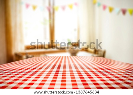 Table background of red and white color and brown wooden window space. Free space for your decoration. 