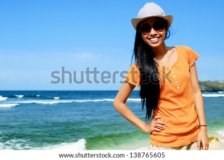 Beautiful Asian woman at the beach enjoying the summer holidays