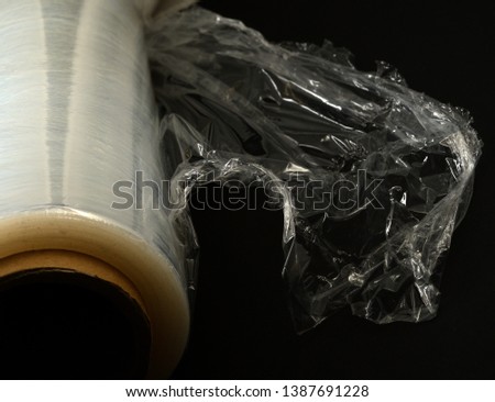 plastic food wrap on a black background