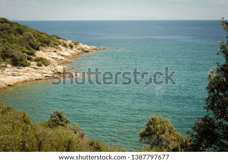 Beautiful sea bays on the Greek peninsula Halkidiki. Blue water and high green forests