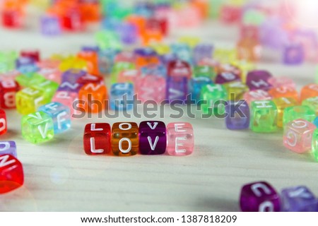colored beads letters on a light background, beads for bracelets with names