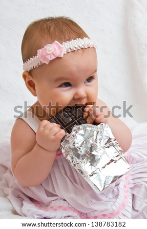Little Girl with a chocolate bar in his hands