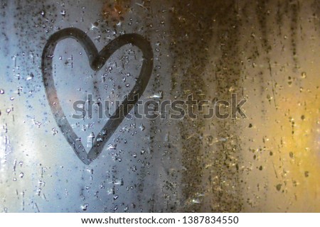 The image of the heart on the misted window. Concept: sad mood, sadness and boredom for a loved one.